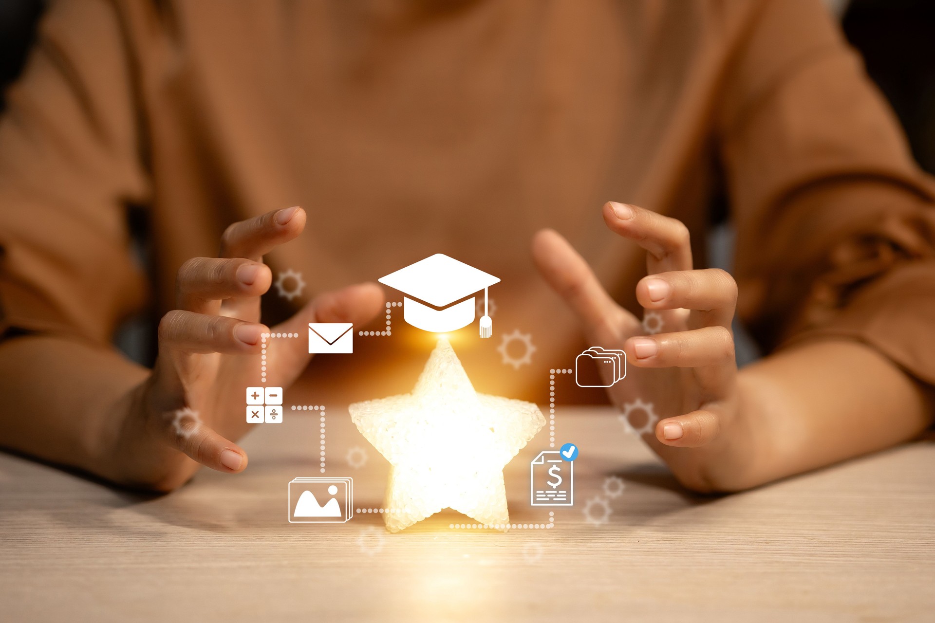 Hands framing a glowing star surrounded by educational and financial icons